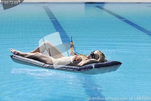 Image of woman relax on swimming pool