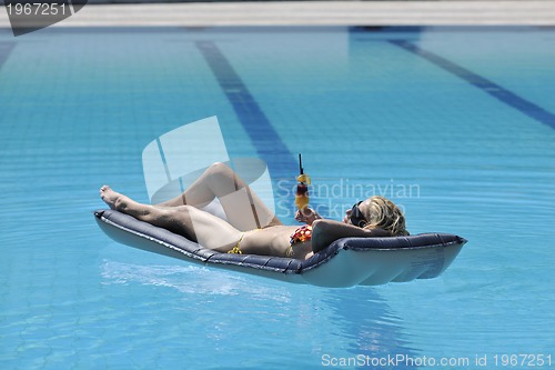 Image of beautiful woman relax on swimming pool