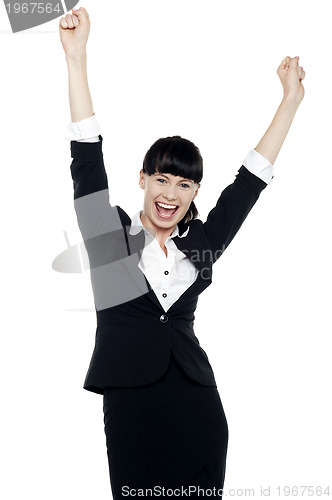 Image of Jubilant corporate lady throwing up her hands