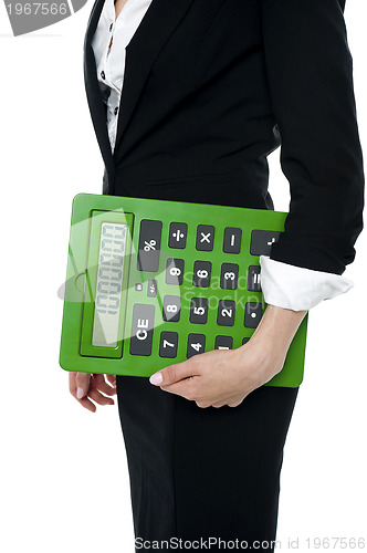 Image of Cropped image of a woman holding big calculator