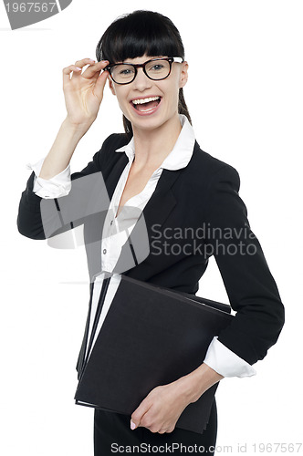 Image of Cheerful female secretary carrying business files