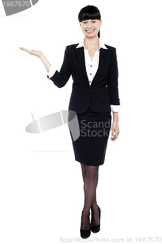 Image of Young beautiful businesswoman showing copy space