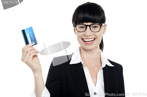 Image of Cheerful bespectacled woman holding up her cash card