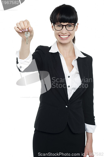 Image of Real estate executive showing house key