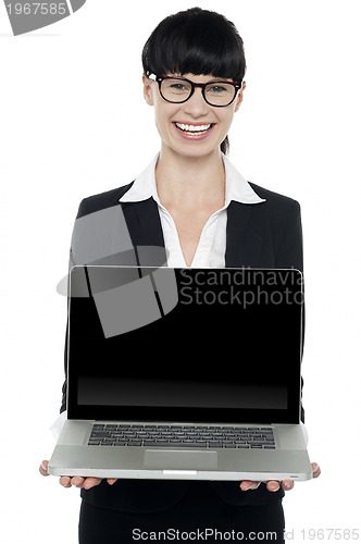 Image of Confident young executive presenting laptop