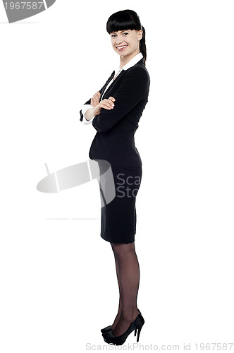 Image of Cheerful confident business lady posing with arms crossed