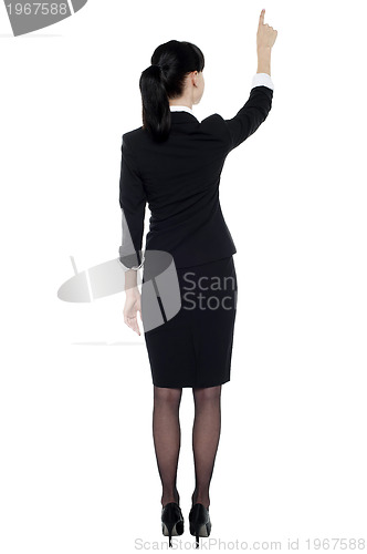 Image of Professional corporate lady pointing at copy space area