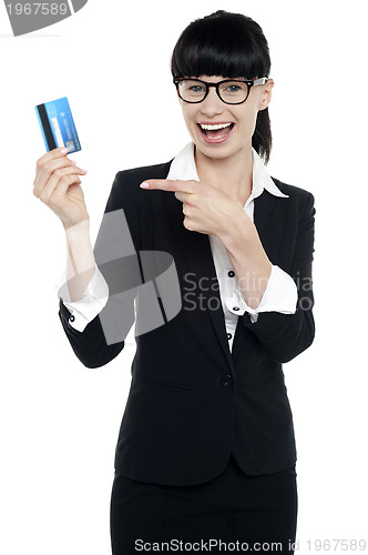 Image of Businesswoman in glasses pointing at credit card