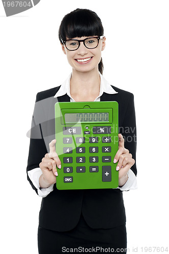 Image of Pretty female executive showing calculator