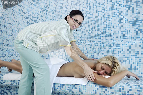 Image of woman relaxing at spa and wellness