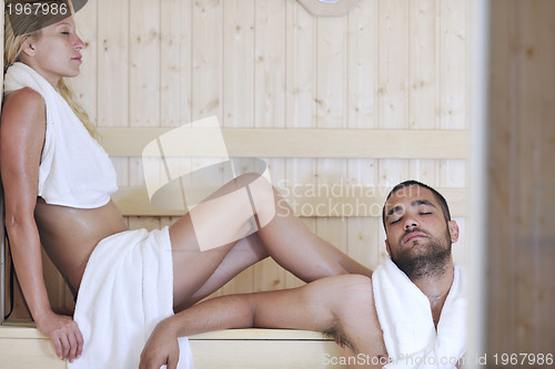 Image of happy young couple in sauna