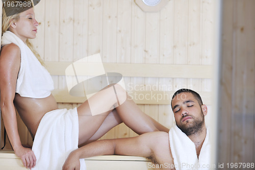 Image of happy young couple in sauna