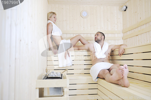 Image of happy young couple in sauna