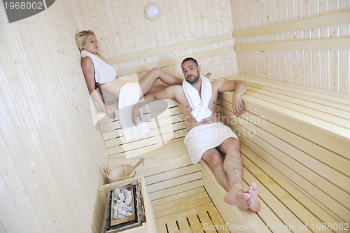 Image of happy young couple in sauna