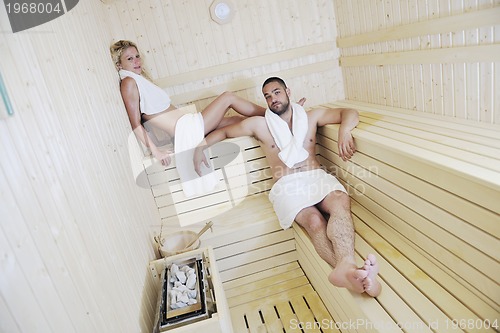 Image of happy young couple in sauna