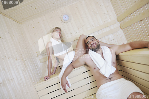 Image of happy young couple in sauna