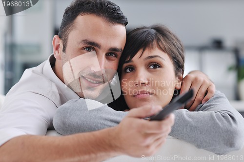 Image of Relaxed young  couple watching tv at home