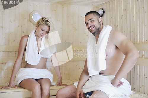 Image of happy young couple in sauna