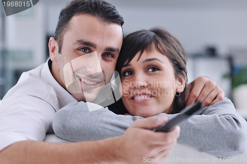 Image of Relaxed young  couple watching tv at home