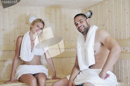 Image of happy young couple in sauna