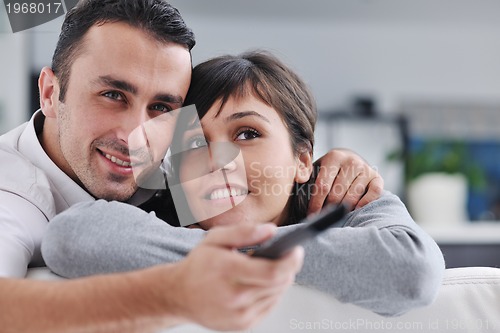 Image of Relaxed young  couple watching tv at home