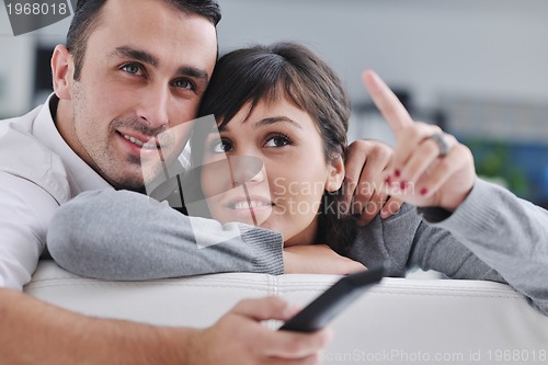 Image of Relaxed young  couple watching tv at home
