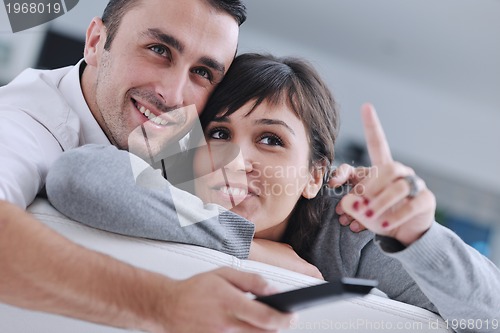 Image of Relaxed young  couple watching tv at home