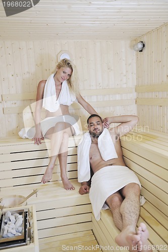 Image of happy young couple in sauna