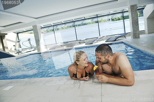 Image of happy cople at swimming pool