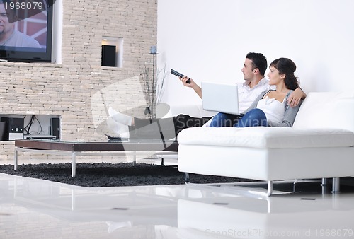 Image of Relaxed young  couple watching tv at home