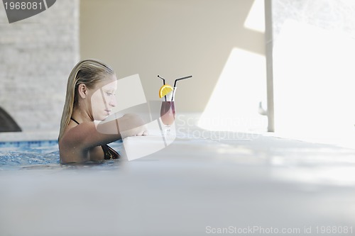 Image of beautiful woman relax on swimming pool