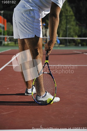 Image of young man play tennis