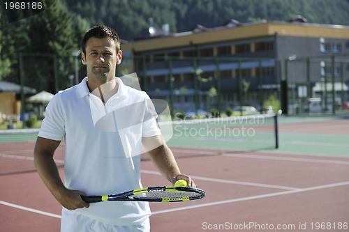 Image of young man play tennis outdoor