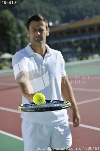 Image of young man play tennis outdoor
