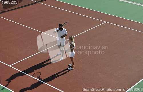 Image of happy young couple play tennis game outdoor