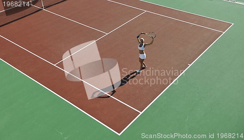 Image of young woman play tennis outdoor