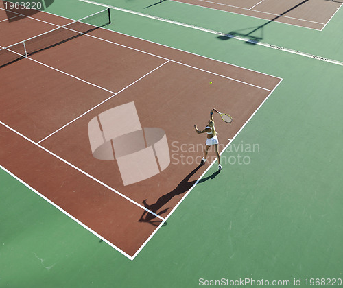 Image of young woman play tennis outdoor