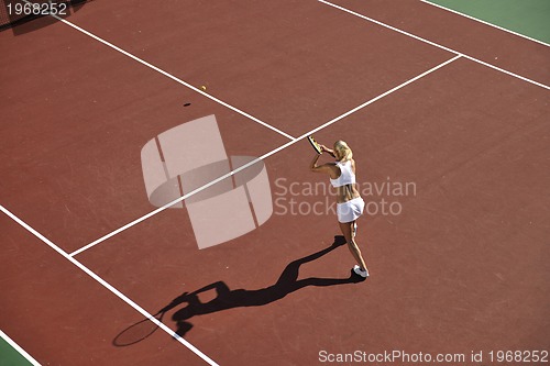 Image of young woman play tennis outdoor
