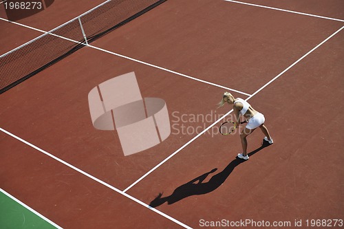 Image of young woman play tennis outdoor