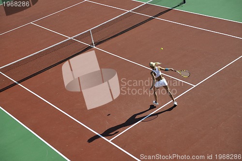 Image of young woman play tennis outdoor