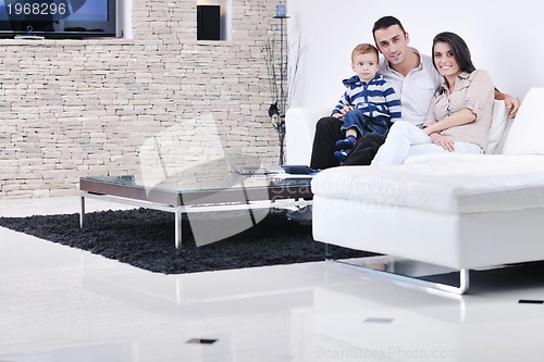 Image of happy young family have fun  with tv in backgrund