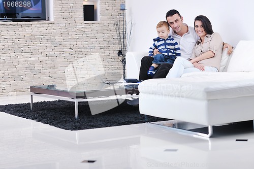 Image of happy young family have fun  with tv in backgrund