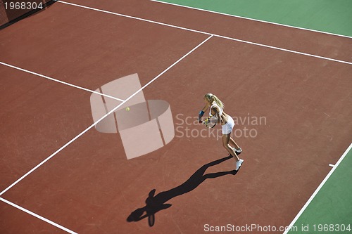 Image of young woman play tennis outdoor