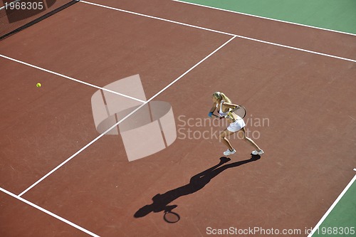 Image of young woman play tennis outdoor