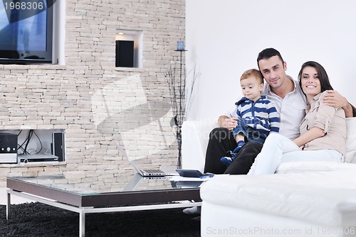 Image of happy young family have fun  with tv in backgrund