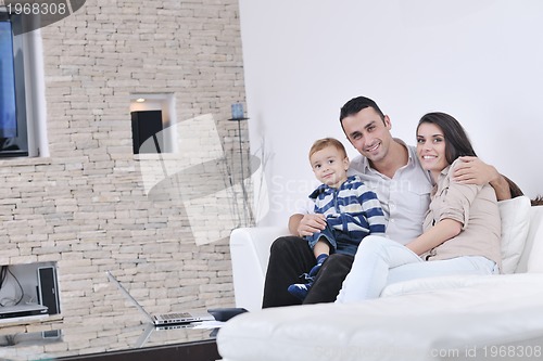 Image of happy young family have fun  with tv in backgrund