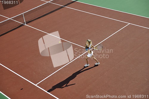 Image of young woman play tennis outdoor