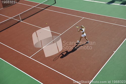 Image of young woman play tennis outdoor