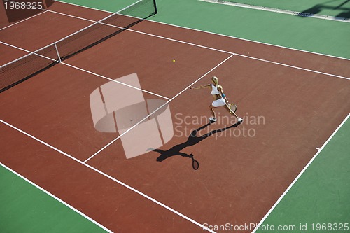 Image of young woman play tennis outdoor