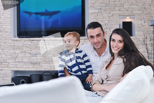 Image of happy young family have fun  with tv in backgrund